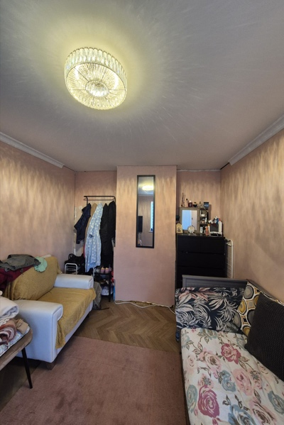 Bedroom before bespoke fitted wardrobe installation showing the underused wall and limited existing storage in Milton Keynes